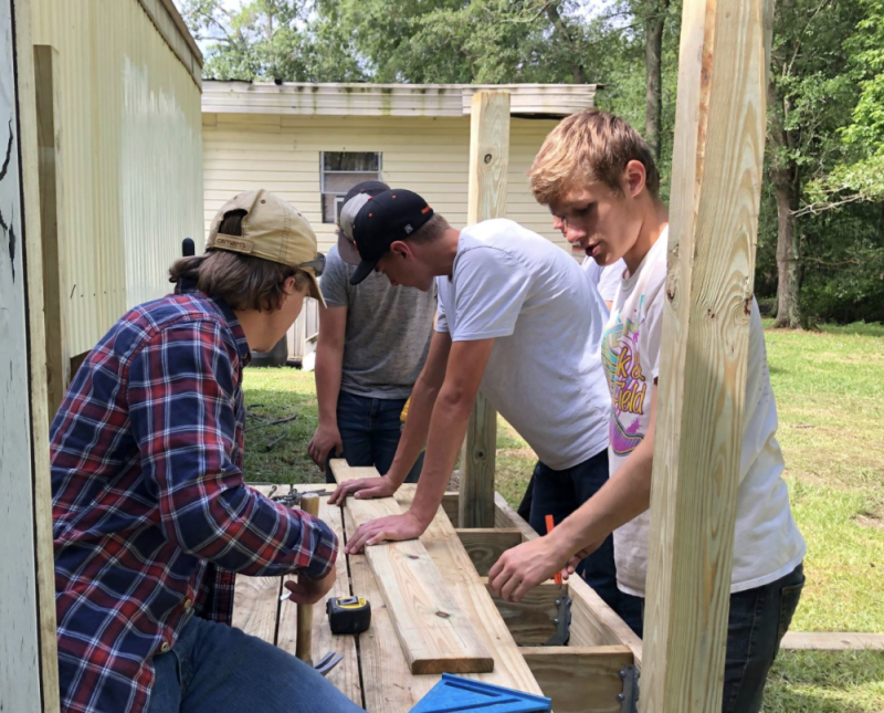 teens constructing porch